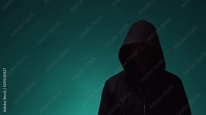 Portrait of computer hacker in hoodie. Obscured dark face. Data thief, internet fraud, darknet and cyber security .