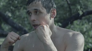 Man trains box in the rain - Free Stock Video