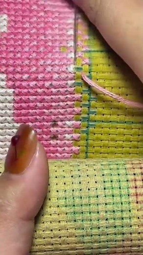 sewing thread onto a medium used to fill each box with colored thread to form a picture