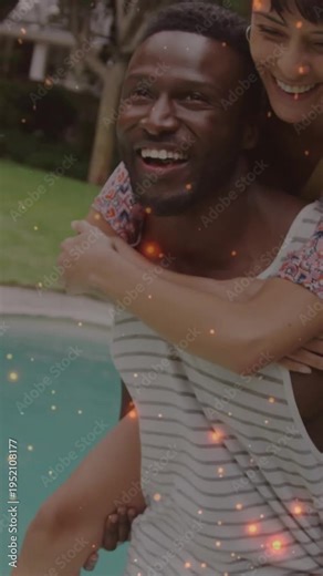 Man carrying woman on back by pool, sparks appearing across faces via overlay for marketing