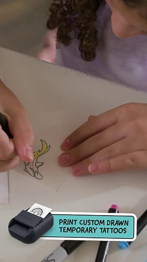 The Hello Blink Tattoo Maker uses ink-free technology to print your doodles directly onto special tattoo paper—no cartridges, no mess! Simply upload your drawings, print, color, and apply temporary tattoos to skin with ease. Find it at Walmart. #HelloBlinkTattooMaker #Walmart | Buffalo Games