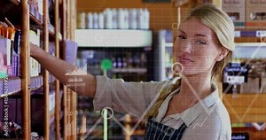 Store clerk removing box and replacing stock while inventory graphs updating levels