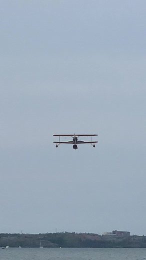 Stunning Biplane Aerial Maneuvers Over Calm Water