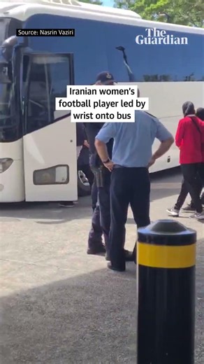 Iranian women’s football team player led by wrist onto bus