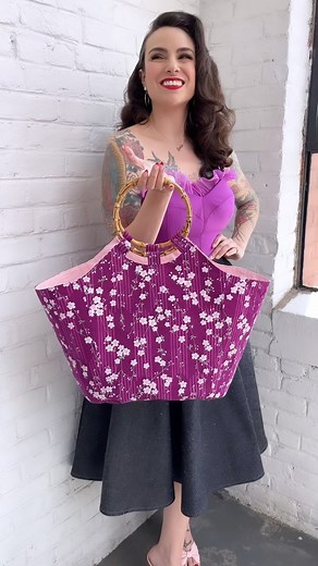 Our new Hattie Tote pattern is perfect for summer days! Here’s a peek inside (two interior pockets!!). With nifty bamboo handles, secret pockets, and sturdy construction, this vintage-inspired classic will be a versatile addition to your accessories collection. Get the pattern on Patreon now (Glamour tier and above). Here I’ve paired my tote with an Esther Swimsuit and Charm Circle Skirt in denim. 🐕💜 #hattietote #estherswimsuit #charmpatterns #charmcircleskirt | Charm Patterns by Gertie