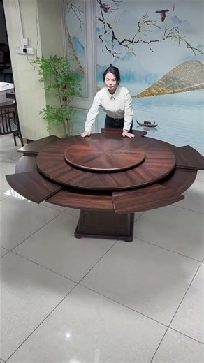 wood round dining table with a rotating center (lazy Susan) and a self-storing expansion mechanism.