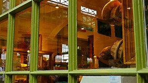 Reflections of people on windows of a bakery
