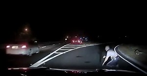Caught on camera: New Jersey police officer rolls away from being hit by car