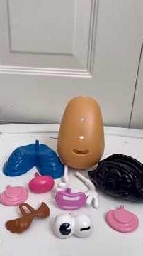 Building Mr.Potato Head apart upside down with eyebrow and black hat ￼