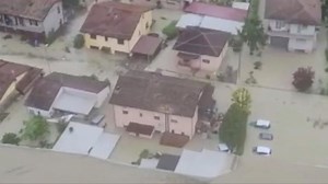 Residents of flooded buildings in Emilia Romagna took to rooftops to await rescue by helicopters.