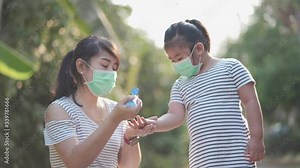 Mother and child face mask during corona virus, hand sanitizer in public place