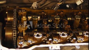 close-up car engine valvematic cover inside and outside, repairmen, fixing motor by professional mechanic. worker opens engine cover with wrench tools, showing details of parts valve, cylinders, chain