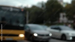 close-up of blurred passenger buses and minibuses moving slowly along city highway during rush hour. public transport on roads of city. slow motion.