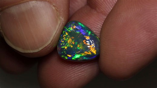 2.7K views · 185 reactions | An incredible Black Opal vibrant with patterns and colors that dance throughout the gem. A truly magical gem! 4.68ct gem black opal 12.3x11x5.6mm https://blackopaldirect.com/product/opal/black-opal/4-68-ct-gem-black-opal-12-3x11x5-6mm/ | Black Opal Direct | Facebook