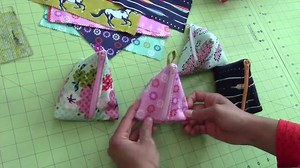 Learn how to make these cute triangular shaped zipper pouches! Video courtesy: TheCraftyGemini | Madam Sew