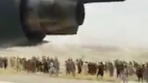Desperate Afghans cling on to a US Air Force plane as it takes off from Kabul
