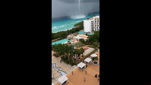 Waterspout Towers Over Shore