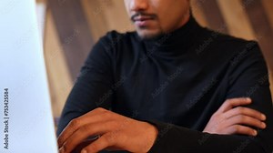 Guy crossing his arms while waiting in front of his laptop, dynamic tilting upward