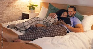 Couple, happy and relax in bedroom with tablet at night, streaming movie and hug. Smile, technology and man and woman in bed on social media app, watching online video and bonding together in home.