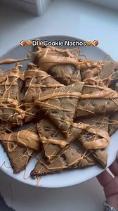 How to cookie nacho 🍪 at home! Ingredients -Nestle Toll House Chocolate Chip Refrigerated Cookie Dough -Nestle Toll House Morsels (Butterscotch, Semi-Sweet, and Premier-White) -"Chip-shaped" Cookie Cutters -Optional: toppings of your choice Make it Step 1 Preheat the oven to 350 F Step 2 Open one package of cookies and place a piece of parchment paper. Cover with an additional piece of parchment paper. Step 3 With a rolling pin, roll the dough out to about 12x9 inches in size and remove top pie