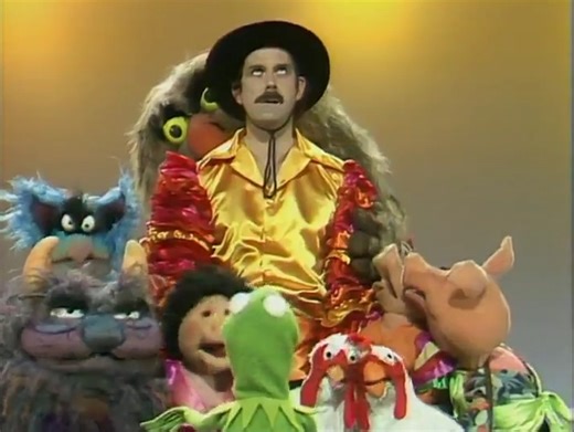 1.7K views · 51 reactions |  'The Muppet Show' Friday 21 October 1977 - ITV: 19:00 John Cleese isn't best pleased with being this weeks special guest star on 'The Muppet Show'. John is tied to his chair before the show, he complains about the number of pigs and monsters present and here, finally gets roped into doing a closing number. #themuppetshow #johncleese | Bernie Briffa | Facebook