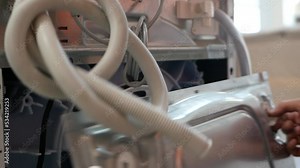 washing machine repair service. the master removes the back cover