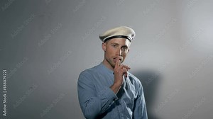 Portrait of a Male Model Wearing a Beret and Pointing Forward
