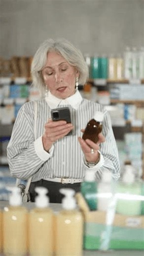 clip-4005117071-mature-woman-scans-barcode-through-camera-on