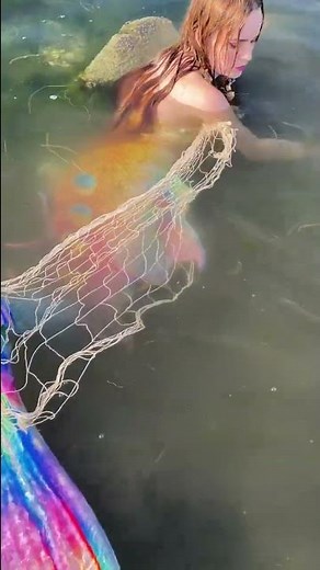 Mermaid caught in fishing net..