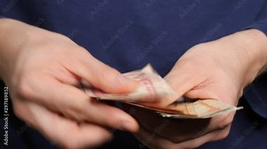 Man's hands counting Nepalese Rupee banknotes. National Currency of Nepal (NPR)