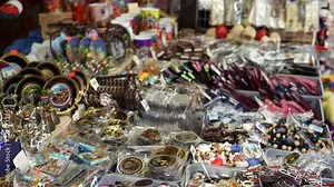 PRAGUE, CZECH REPUBLIC - 25 MAY 2019: Tourist buying souvenirs at the street at the Old Town. Beautiful sunny atmosphere, outdoor famous market in the Old Town of Prague, Czech Republic, Europe. Stock Video