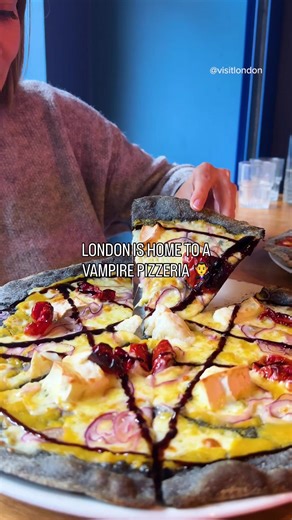 Dare to dine with the undead this Halloween?🦇🍕 Head to Lost Souls Pizza - London’s vampire-themed pizzeria serving up black charcoal crusts, blood-red cocktails, and serious spooky vibes. Hidden in a crypt beneath Camden, it’s the perfect Halloween haunt for creatures of the night (and pizza lovers). #LondonMakesItPossible #VisitLondon #LostSoulsPizza #HalloweenInLondon #VampireVibes #LondonEats #SpookySeason | Visit London