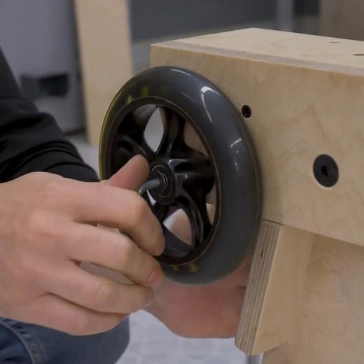 Installing the wheels of the woodworking workstation