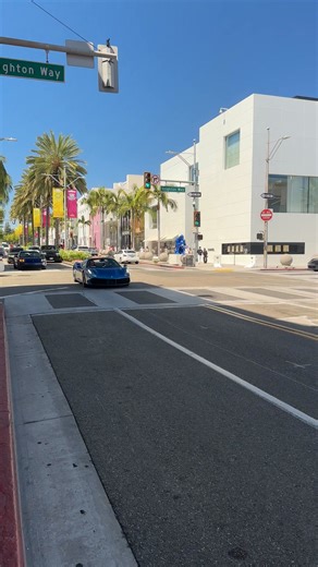 A striking blue Ferrari 488 Spider was spotted cruising down Rodeo Drive, blending high-end style with heart-pounding performance. Powered by a 3.9L twin-turbo V8 delivering around 660–670 hp, this drop-top marvel rockets from 0–60 mph in just 3.0 seconds and reaches up to 203–205 mph, all while maintaining Ferrari’s signature aerodynamic elegance ￼ ￼ ￼ ￼ ￼ ￼. With a base MSRP hovering around $245,000–$275,000 when new, well-preserved examples currently trade in the $300,000 range, thanks to gro