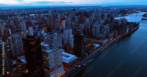 Hard traffic by the highway on the waterfront of Hudson River. Splendid scenery of New York, the USA at dusk. Aerial view.