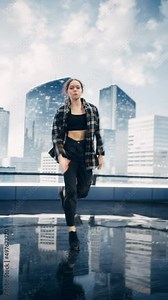 Vertical Screen: Stylish Young Professional Female Dancer Performing a Hip Hop Dance Routine in Front of Big Led Wall Screen with Modern City Skyline with Office Skyscrapers in Studio Environment.