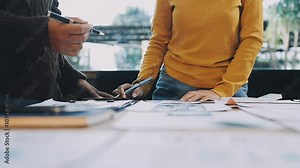 Web design process. The web designer creating a mockup of the mobile application according to the customer's brief. Samples and sketches laying at the table