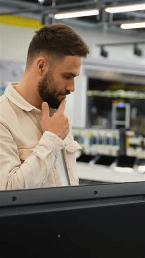 clip-3988887857-customer-using-self-checkout-kiosk-modern-supermarket