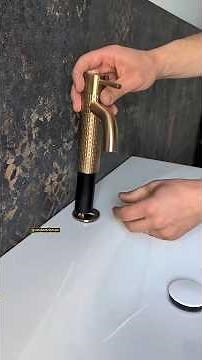 Installation of a modern bathroom vanity with integrated sink and soft-close drawers.