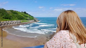 Tourist woman enjoying the views of the beaches of Getaria in the Basque Country.