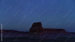 Timelapse of stars, Lone Rock at Lake Powell, Utah in foreground. Night to sunrise holy grail