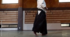 Student in dojo with sensei for aikido fight training, fitness and development with action, exercise and coaching. Teaching, learning and men in traditional Japanese martial arts class with aikidoka.