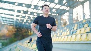 clip-1082368024-young-asian-runner-running-on-modern-urban