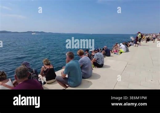 ZADAR, CROATIA - AUGUST 17, 2025: Tourists gathering at the famous Sea Organ (Morske orgulje) on the waterfront of Zadar on a sunny summer day Stock Video Footage - Alamy