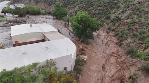 Flash floods hit Arizona, washing away roads and flooding buildings