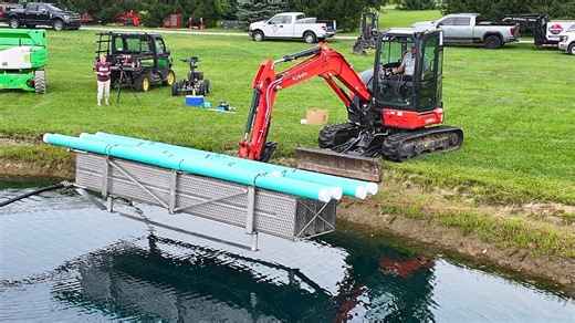 DROPPING a Giant Heat Exchanger in Our POND! Tractor Time with Tim is installing a Slim Jim heat exchanger in the pond for the geothermal system for the Dream Shop! The geothermal system will provide heating and cooling for the shop and office creating a sustainable hvac system. The team explains the process of installing the exchanger and connecting the system. Indiana Geothermal , #heatexchanger, #slimjim, #geothermal, #tractortime, #ttwt | Tractor Time with Tim