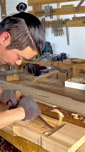 Using A Wood Chisel To Carefully Hollow Out A Deep Recess In A Large Timber Plank