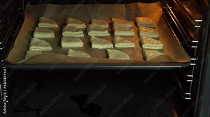 Man puts dough on a baking sheet in the oven for baking cookies. Homemade fresh baked recipe. Delicious craft biscuit