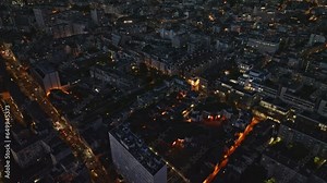 A breathtaking aerial view of Paris's 13th arrondissement, with illuminated high-rises showcasing unique architectural beauty.