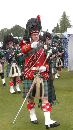 Drum Major Ian Esson leads Ballater & District Pipe Band on the march as they start their public display during the 2023 Aboyne Highland Games. These were held on a rather wet Saturday 5th August 2023 at Aboyne in Aberdeenshire, Scotland, and the band were playing Father John MacMillan of Barra and Greenwood Side. Having formed in 1867, Aboyne is regarded as "The Traditional Highland Games" and continues to attract thousands of visitors to watch this wonderful display of Scottish culture in one 